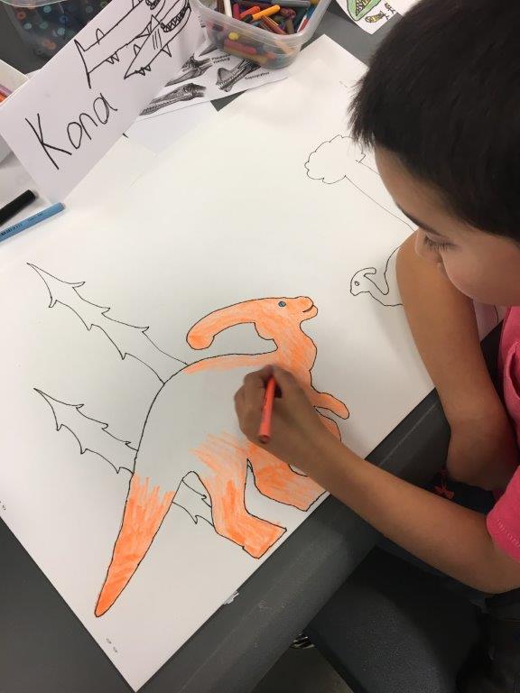 A child drawing a dinosaur