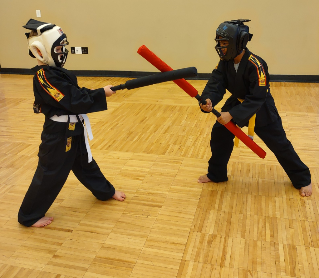 Children practicing with martial arts weapons